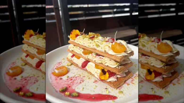 Three-tier pastry with layers of cream and fruit