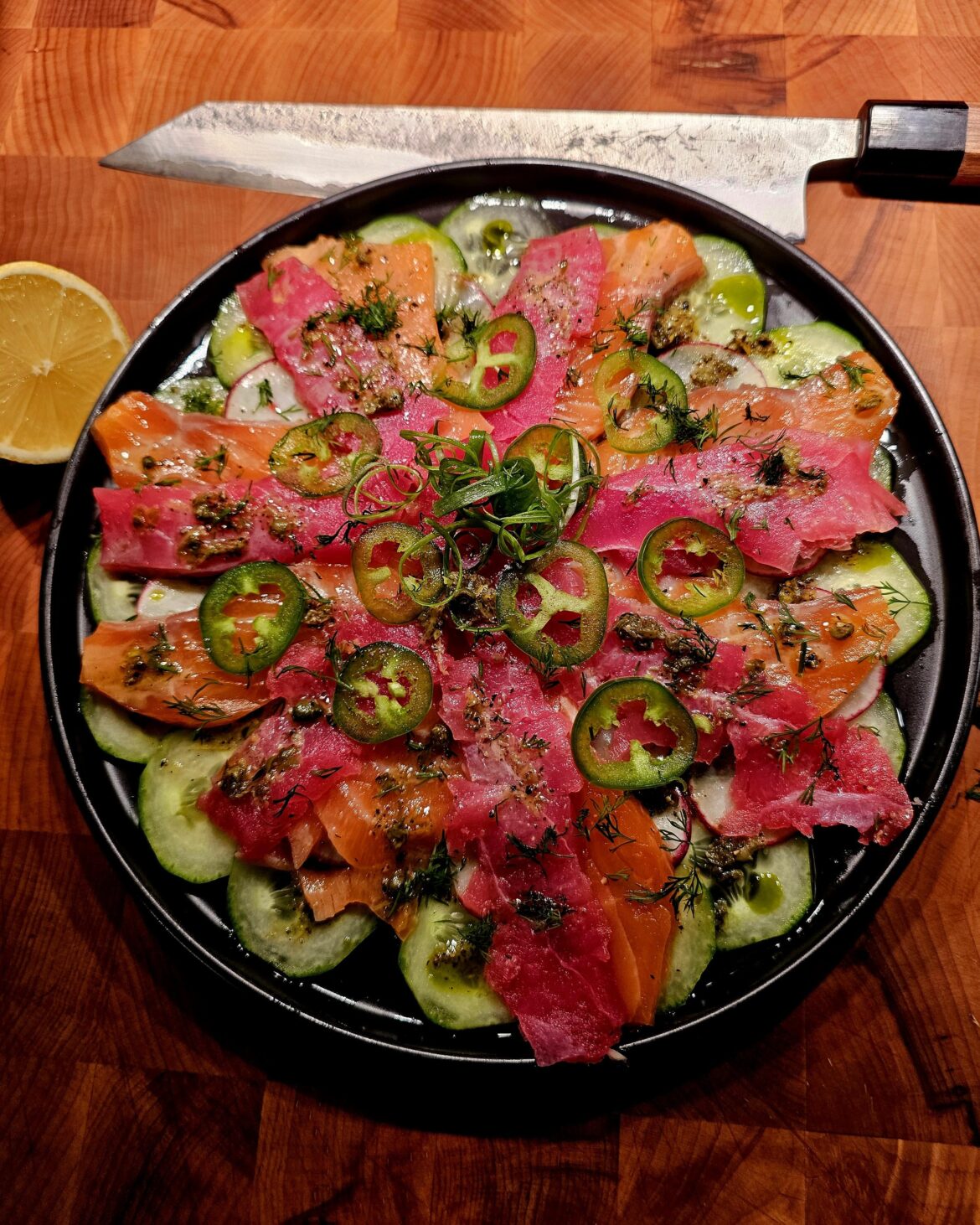 Tuna and salmon crudo over a cumber and radish salad. Topped with a lemon caper vinaigrette.