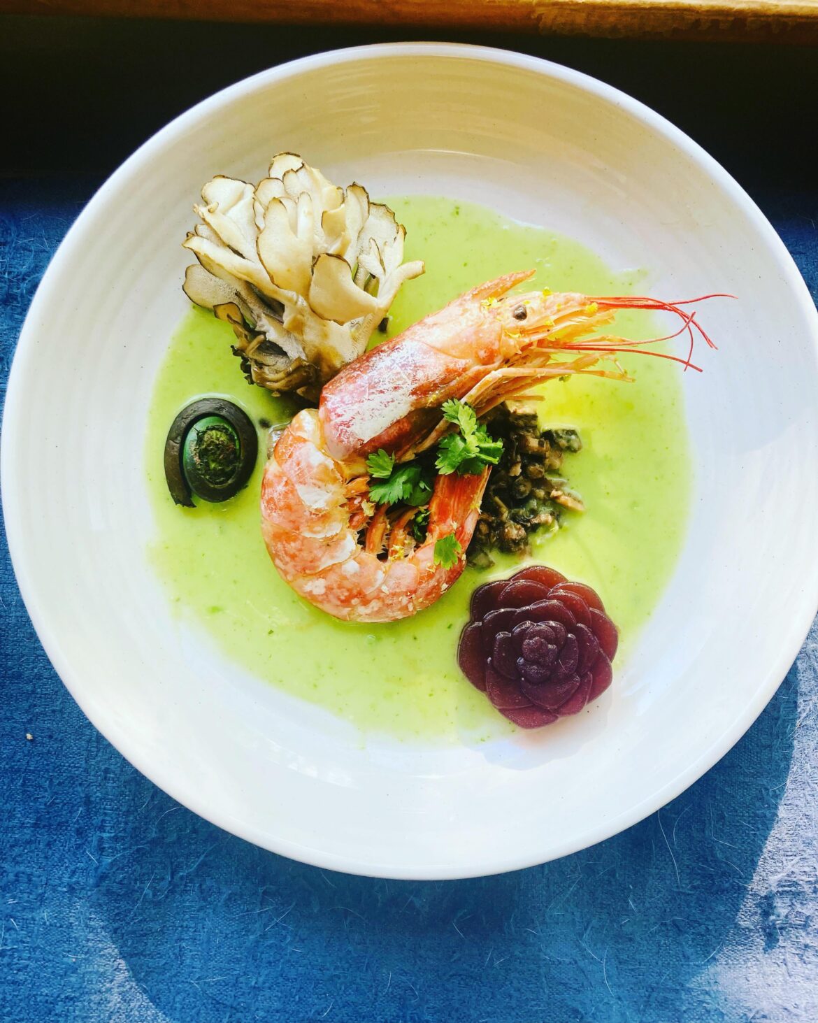Coconut braised prawn w tomatillo vinaigrette , mushroom soil & beet pepper gel