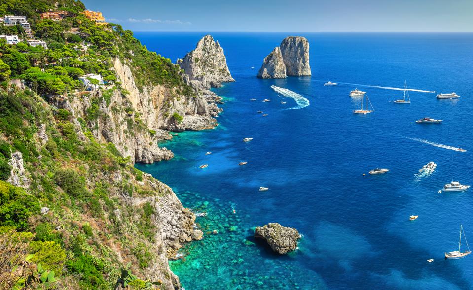 Amazing Faraglioni cliffs panorama with the majestic Tyrrhenian sea in background. Capri island, Campania region, Italy.