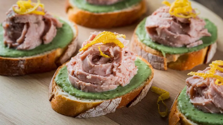 Baccala mantecato served on bread with orange zest on top