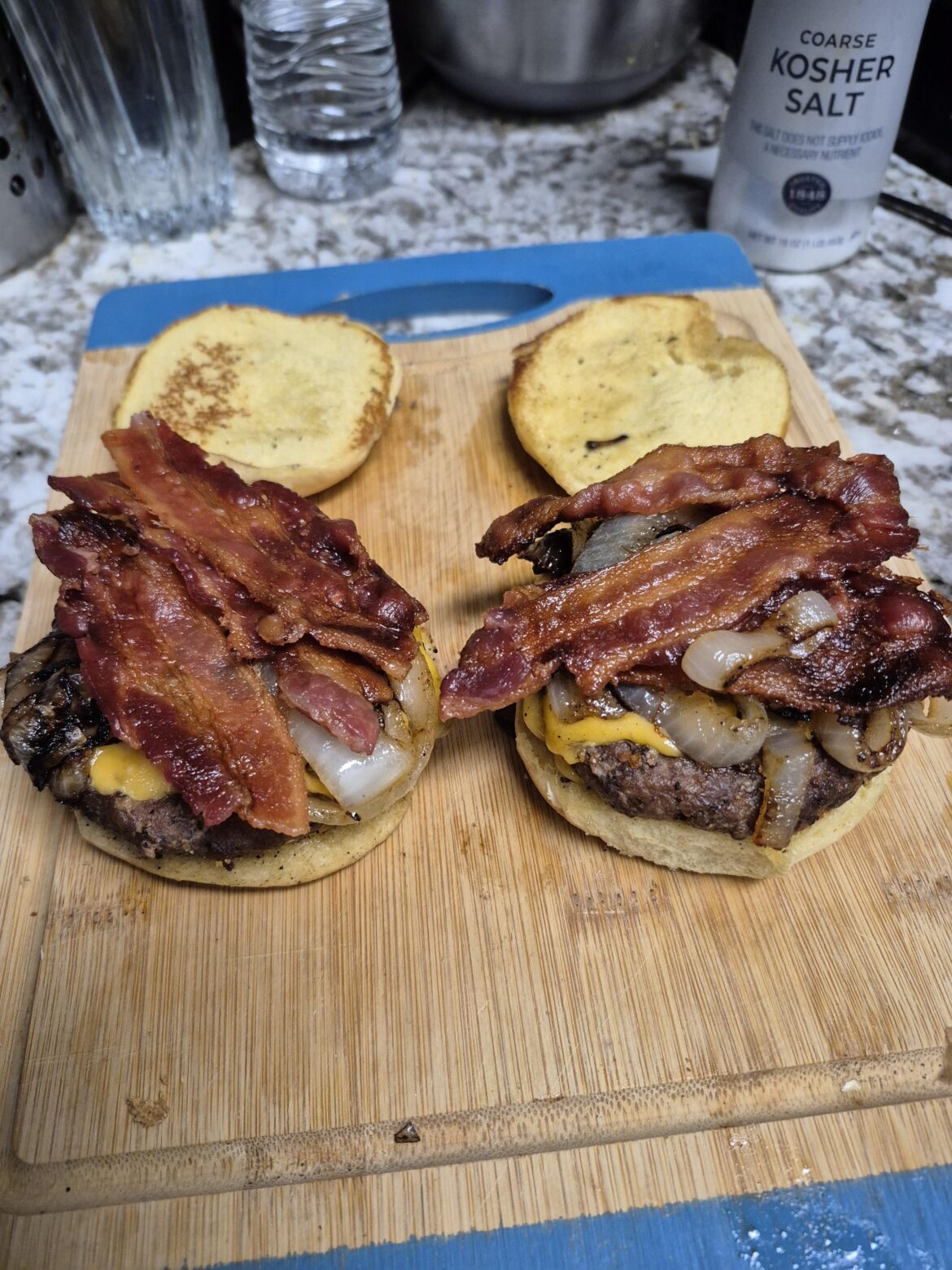 bacon cheese burgers with cooked onions. J