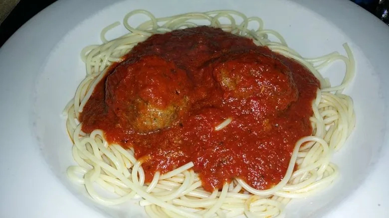 Spaghetti topped with meatballs and red sauce