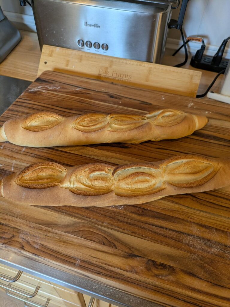 Trying to make Pan De Barra and I accidentally made roset baguettes with the scoring.