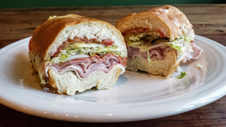 Jersey Mike's Italian Sub, plated, on a wood table.