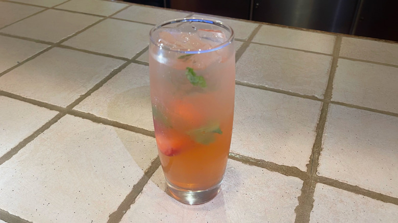 The Spiked Strawberry Lemonade from Olive Garden on a white bar top