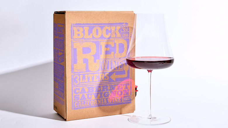 trader joe's wine box on a table with a glass