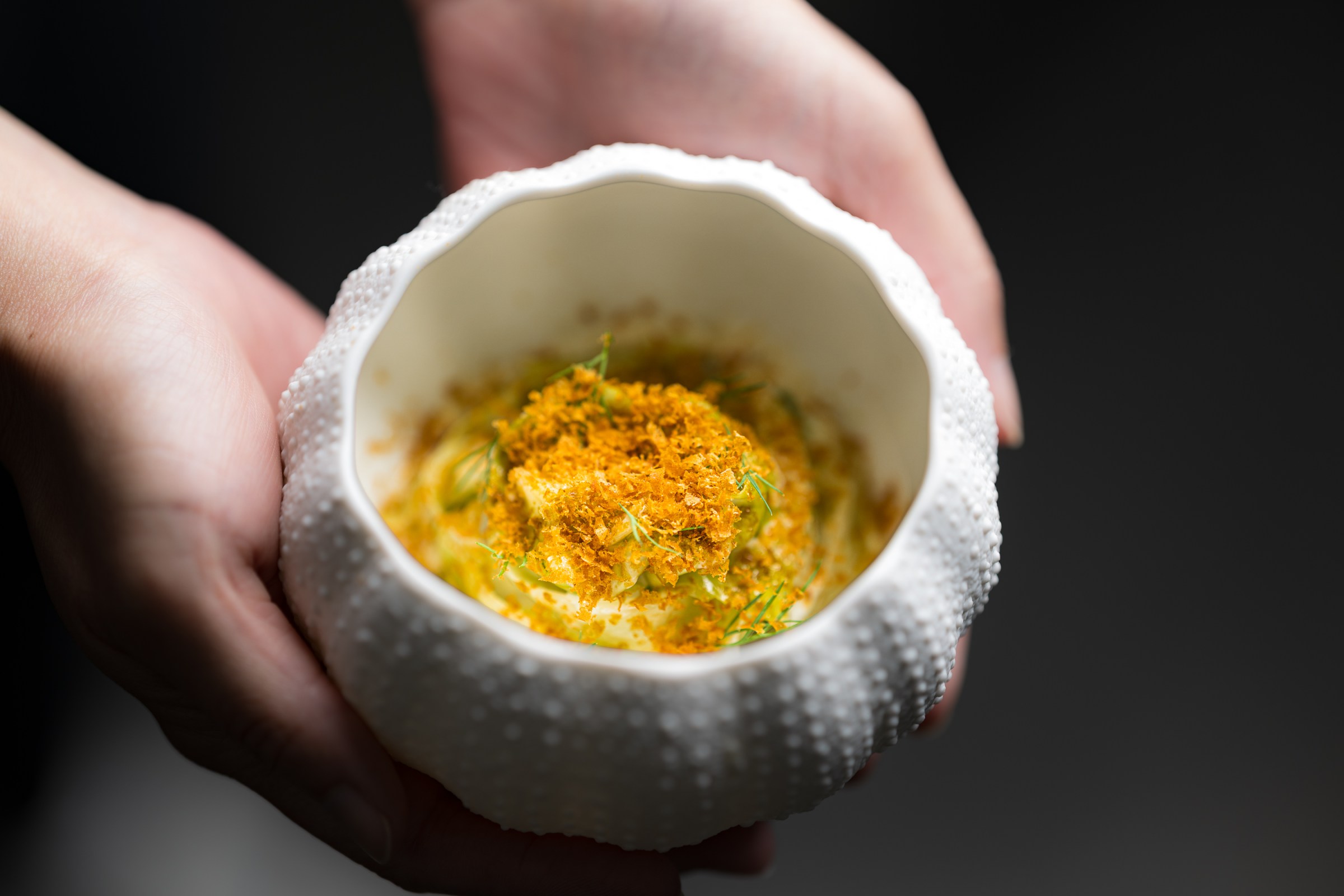 A Wolfsbane dish served in a white sea urchin-shaped bowl.