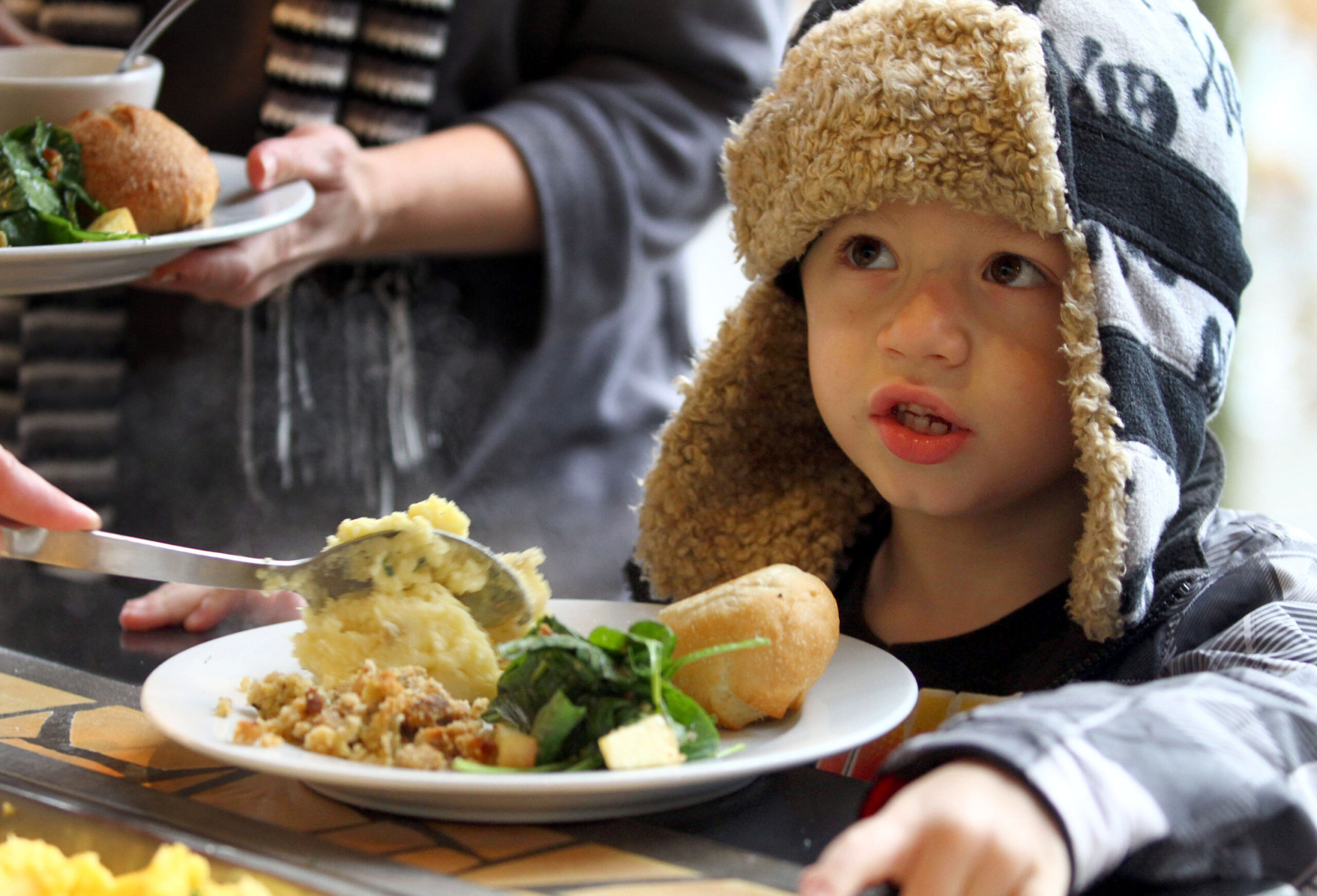Jayce Kalduski, 6, asks for candied sweet potatoes during a Thanksgiving dinner being served at Safari West in Santa Rosa, Nov. 24, 2011. Kalduski, who is from Placerville but visiting family in Sebastopol said, "I love sweet potatoes." (Crista Jeremiason/The Press Democrat)