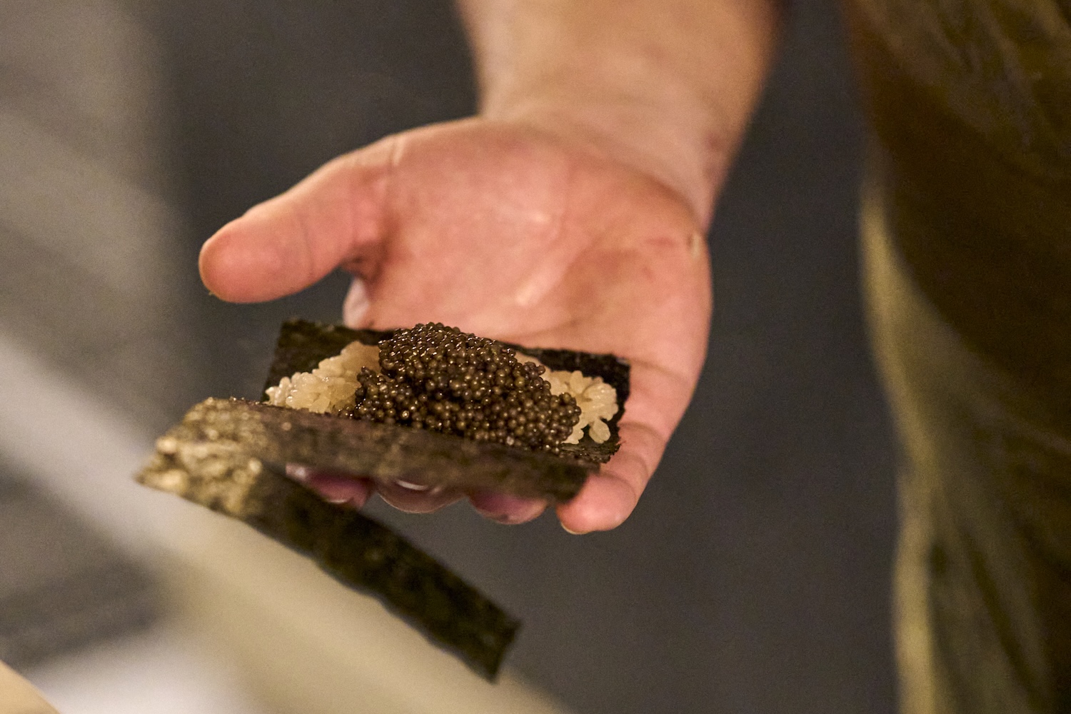 Chef Clonts making the caviar hand rolls at 63 Clinton
