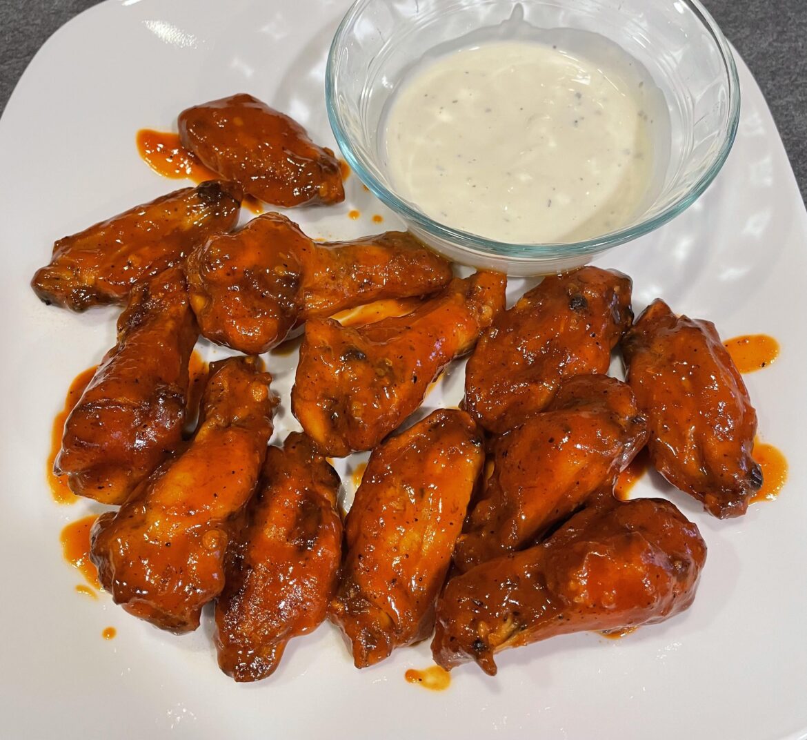 Oven broiled with a custom buffalo sauce and blue cheese ranch