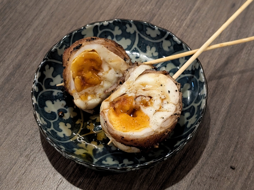 An inventive skewer of a boiled egg wrapped in pork belly. — Picture by Ethan Lau An inventive skewer of a boiled egg wrapped in pork belly. — Picture by Ethan Lau