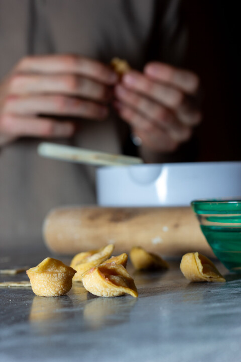 IDENTIFIABLE: The tortellini is folded into a characteristic knot.