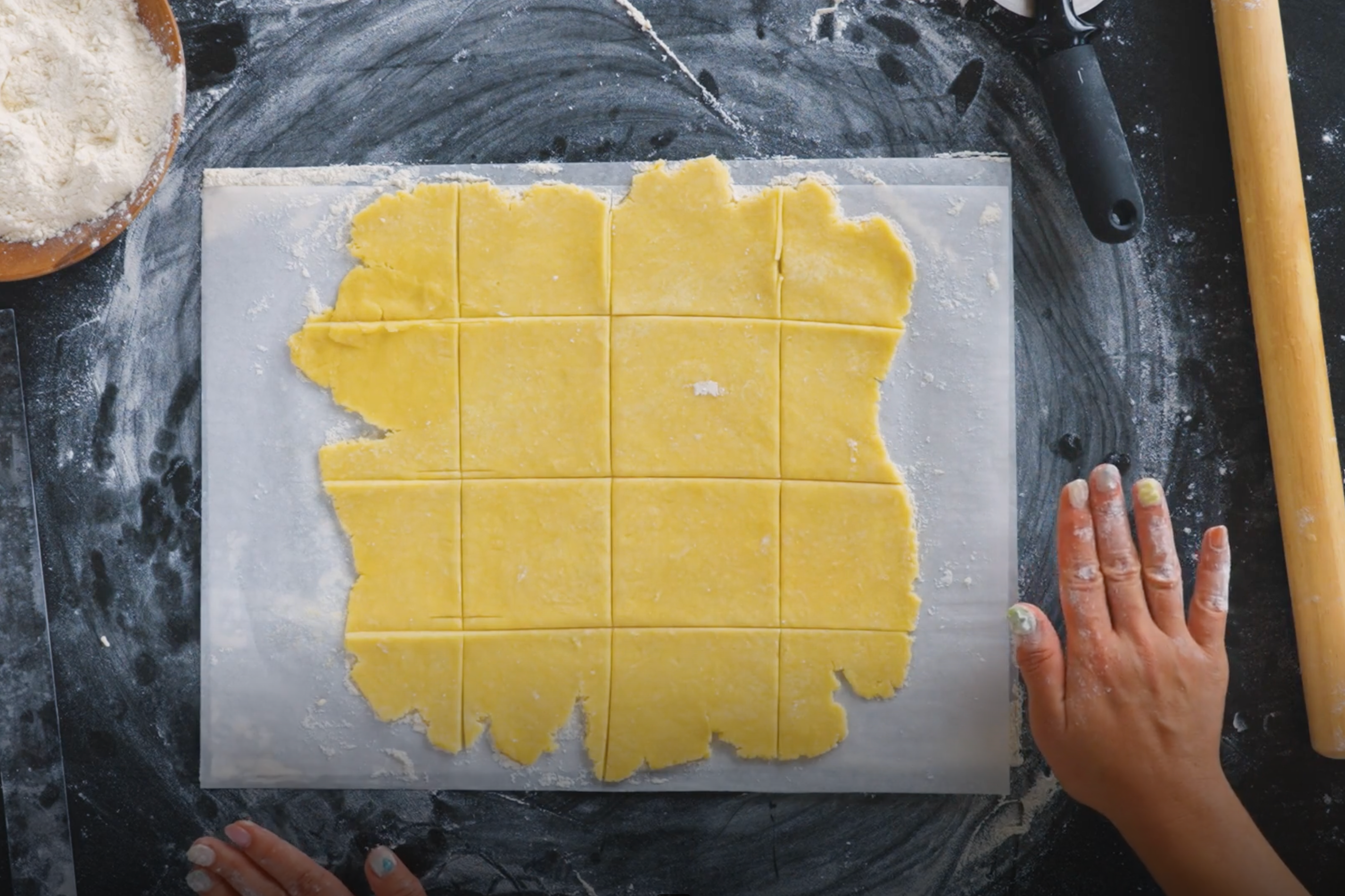 Pie dough rolled out and cut into squares.