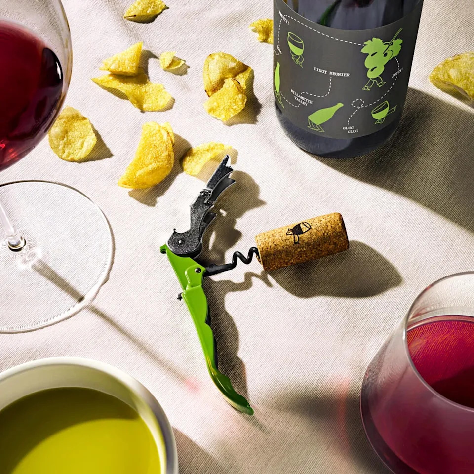 wine accessories including a corkscrew a cork and snacks on a table