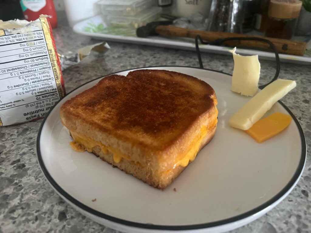 A mix of old cheddar and havarti, with butter and a slight smear of mayo. A bit of salt