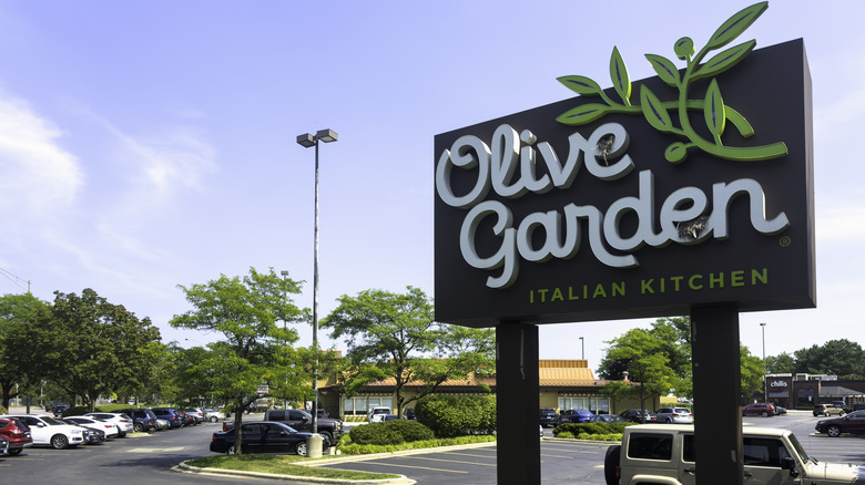 The sign and car park outside an Olive Garden restaurant