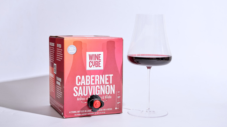wine cube box on a table with a glass