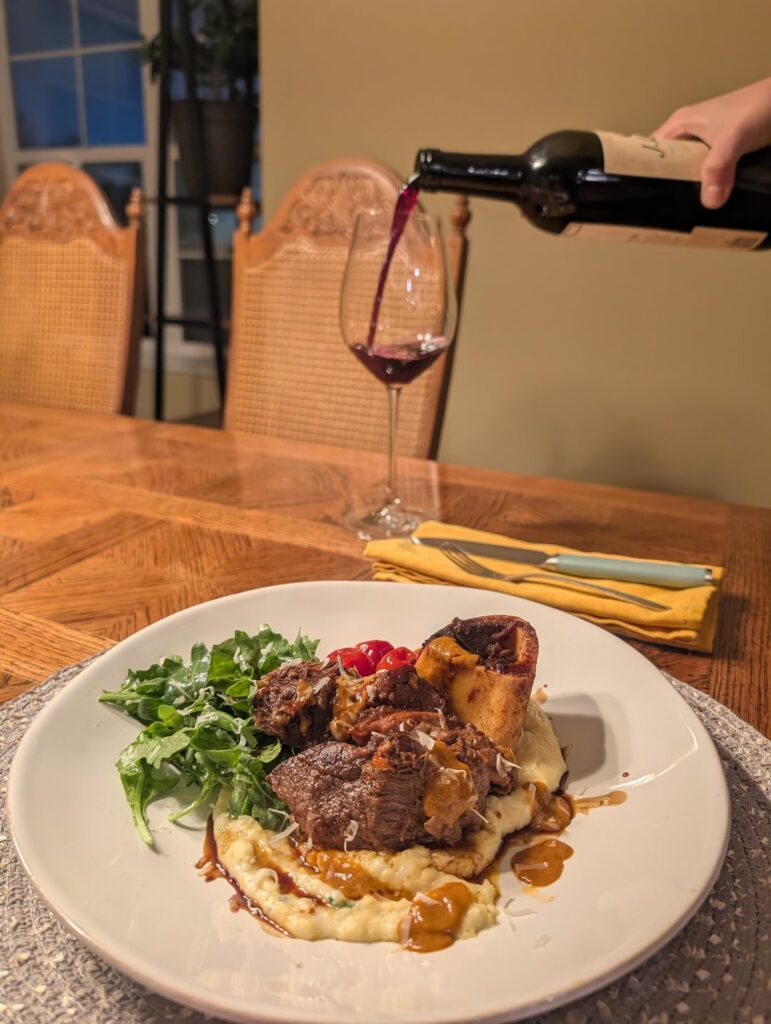 Braised Pork & Beef Shank, Polenta, Dressed Arugula, Cherry Tomatoes.