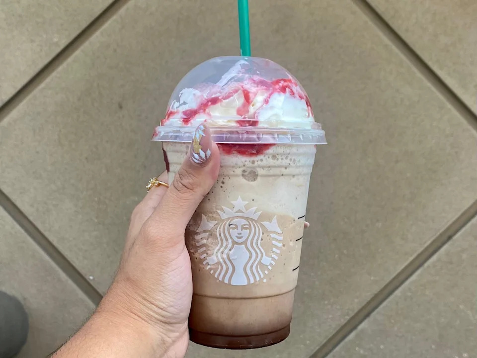 Melissa holding a Starbucks' Grande Frappula.