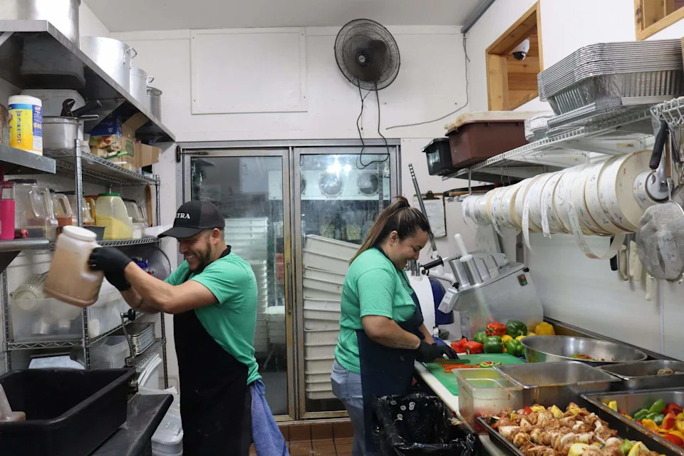 Workers prepare food at Petra Mediterranean Pizza and Grill at 1210 Higuera St in San Luis Obispo.