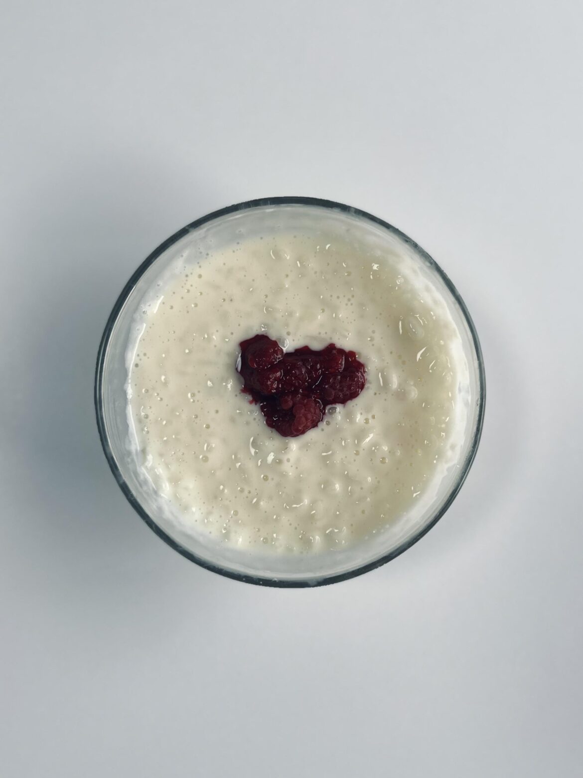 Warm and sweet rice porridge topped with raspberries