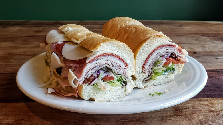 The 5 Meat Italian from Subway, plated, on a wood table.