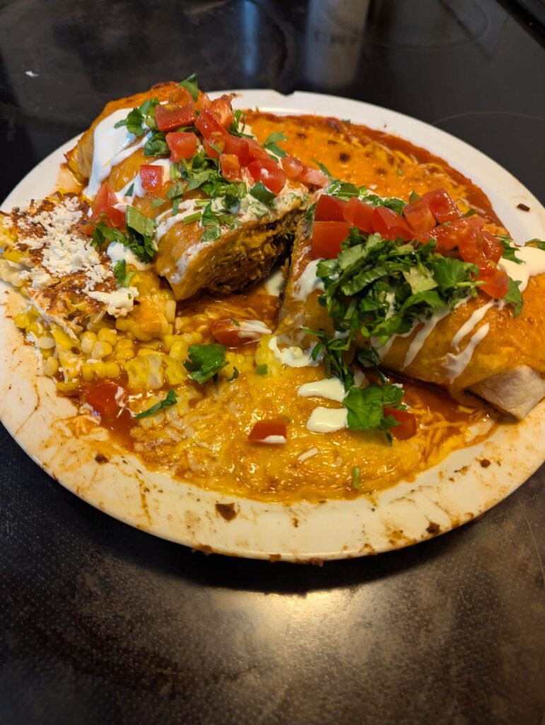 We had a birria taco party Sunday. This is the 3rd day of leftovers. A giant birria (beef), frijoles,and rice burrito smothered in enchilada sauce and covered in cheese.