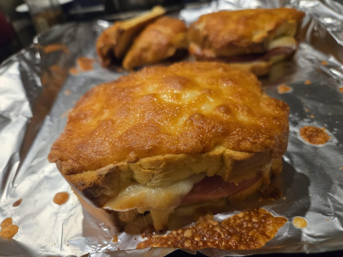 Croque monsieur: Brioche slices with ham, gruyere, and bechamel.