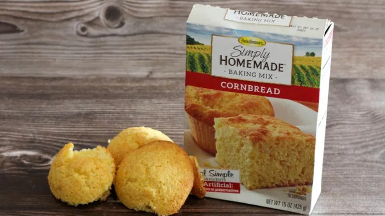 Closeup of a box of Fleischmann's corn bread mix and muffins on a table