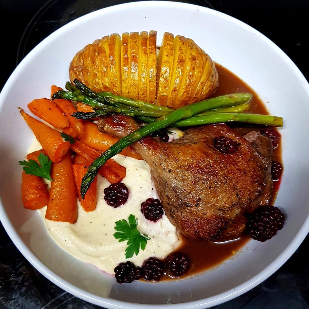 Slow Cooked Duck, Roasted Cauliflower Purée, Sautéed Carrots and Asparagus, and Pickled Blackberries. Spiced Duck Sauce.