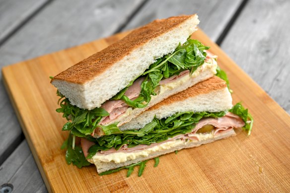 The mortadella panino with layers of dappled pink and white lunch meat, stracciatella, rocket, green olives, honey and pistachio.