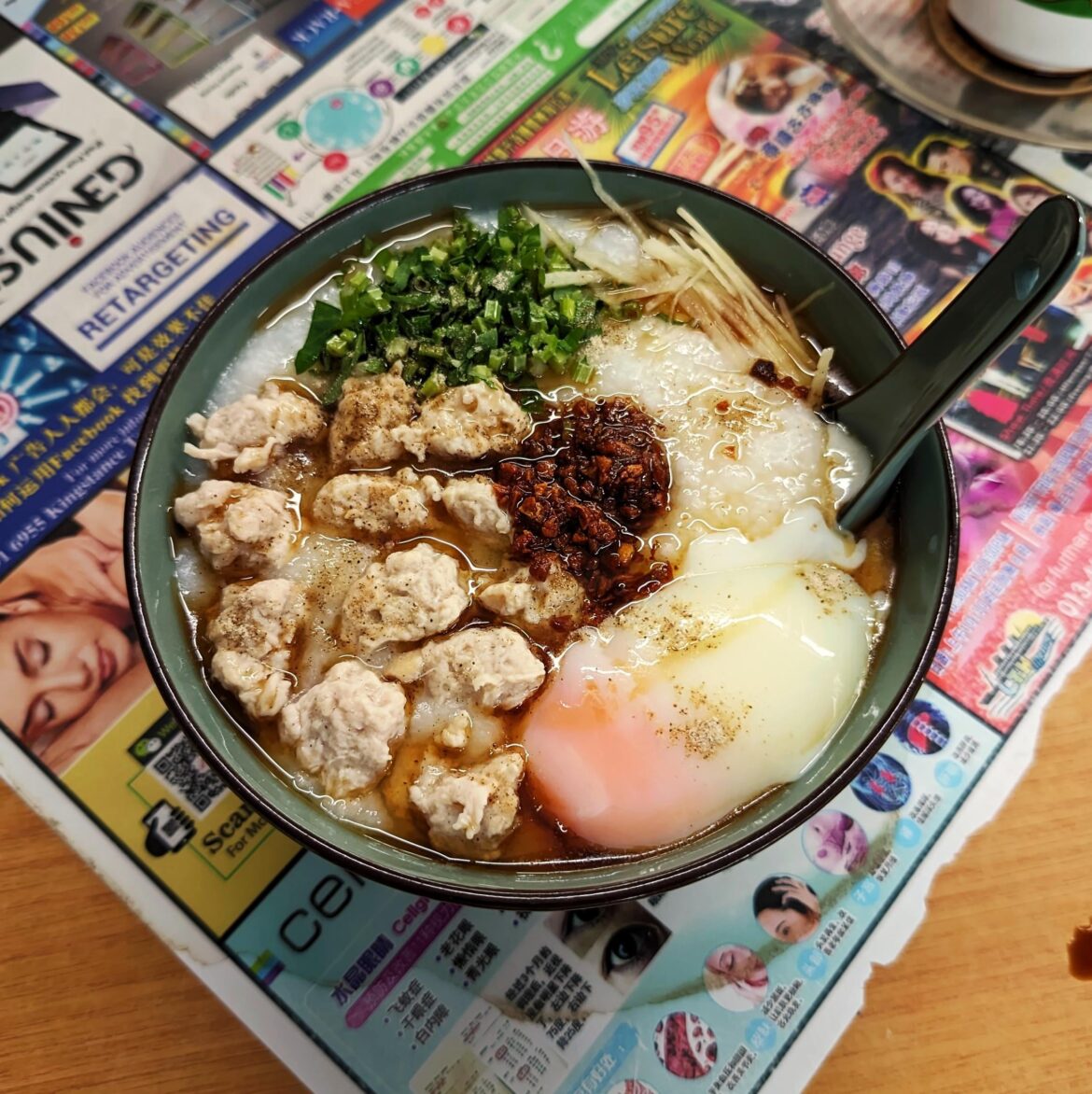 Congee with minced pork and egg, garnished with fried garlic, scallions and ginger