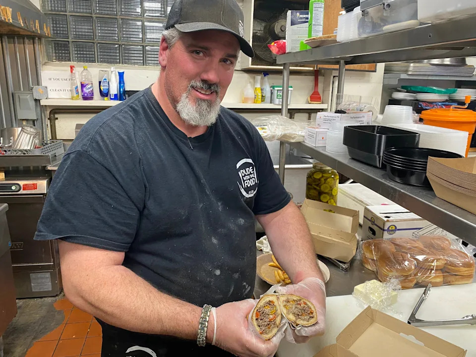 Nathan Levesque, owner of Dude with the Food, shows a Philly cheesesteak sub with peppers and onions at the Portuguese American Civic Club in Taunton on Thursday, Nov. 20, 2025.