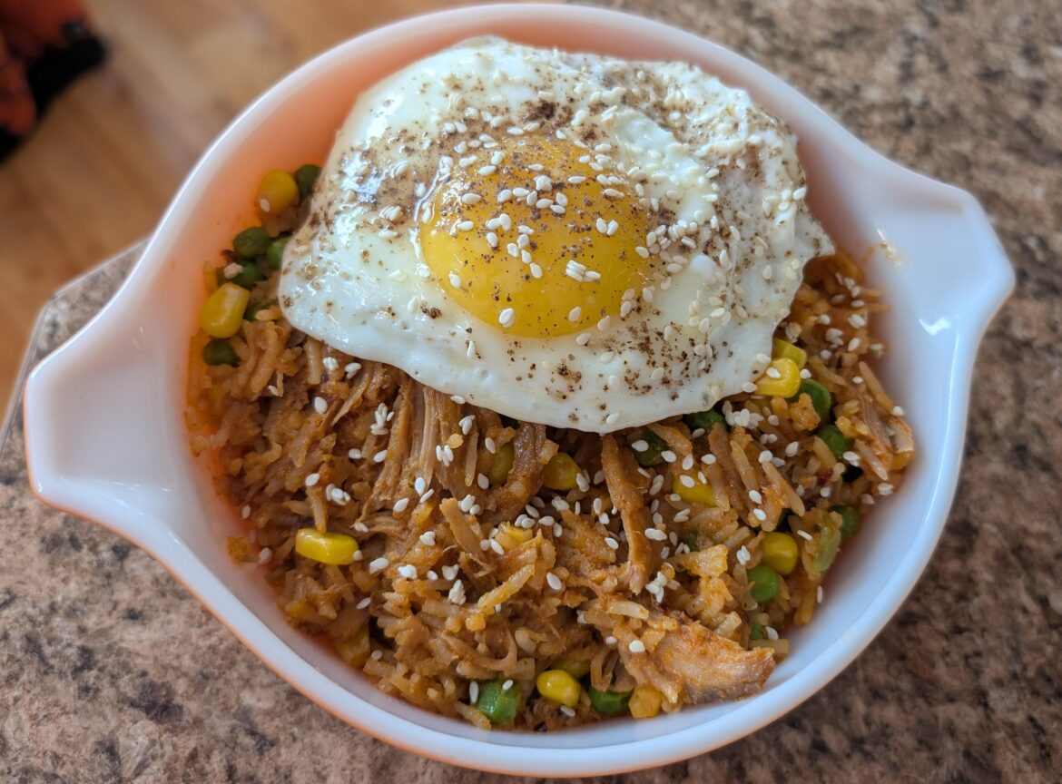 Pulled pork fried rice with runny egg on top 🎩