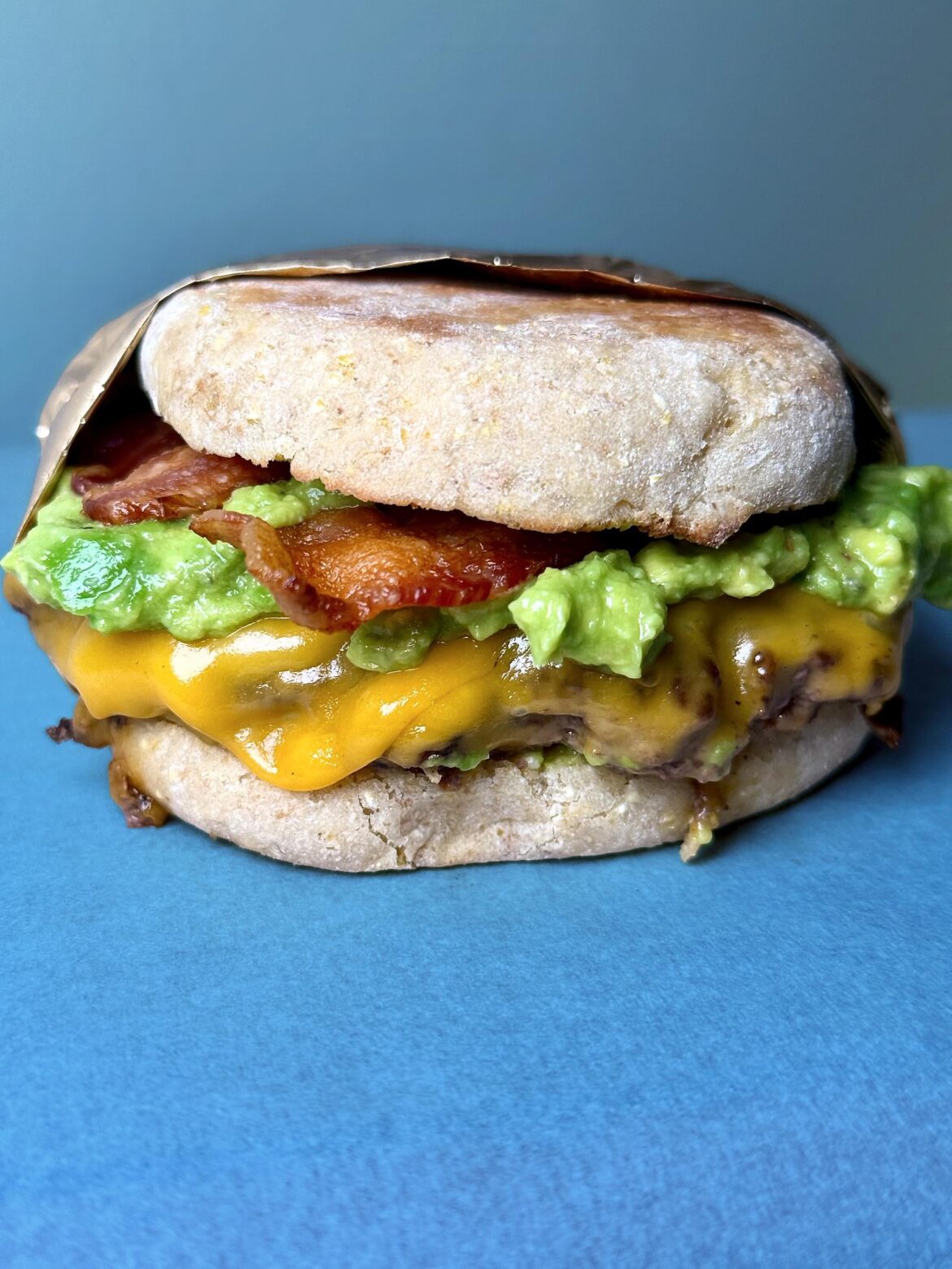 [homemade] 1/3lb patty, bacon, steamed cheddar, homemade guac, English muffin.