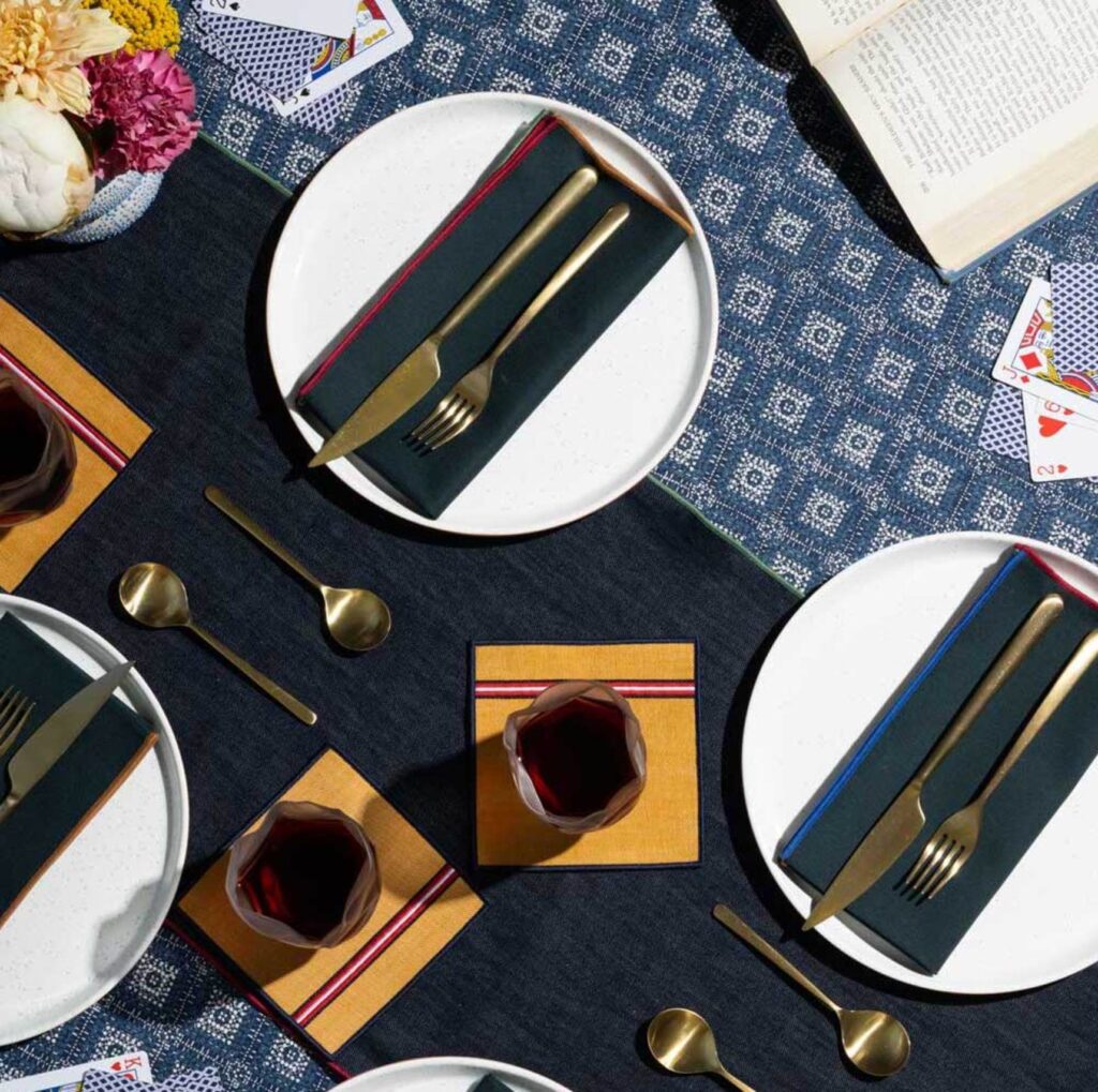 Blue and yellow table linens on a table with playing cards.