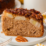 one slice of banana upside down cake on a white plate with a fork