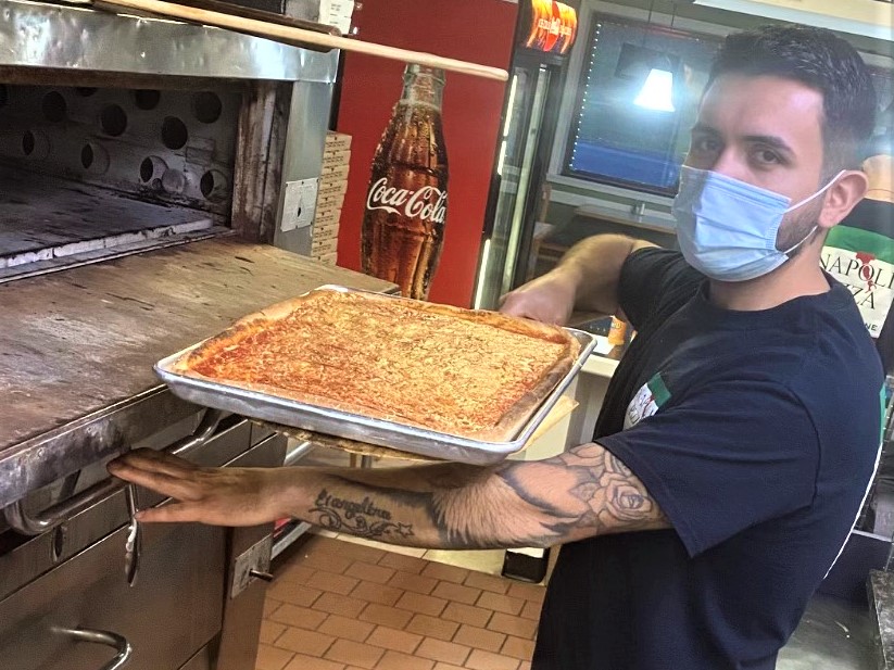 Napoli Pizza + Italian Cuisine owner Walter Roca removes a pizza from the kitchen's pizza oven. The restaurant, offering pizza, pasta and other homemade Italian specialties, opened Jan. 7 at 2013 Willow Park Road in Bethlehem Township.