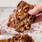 a large piece of pretzel toffee bark held in fingers