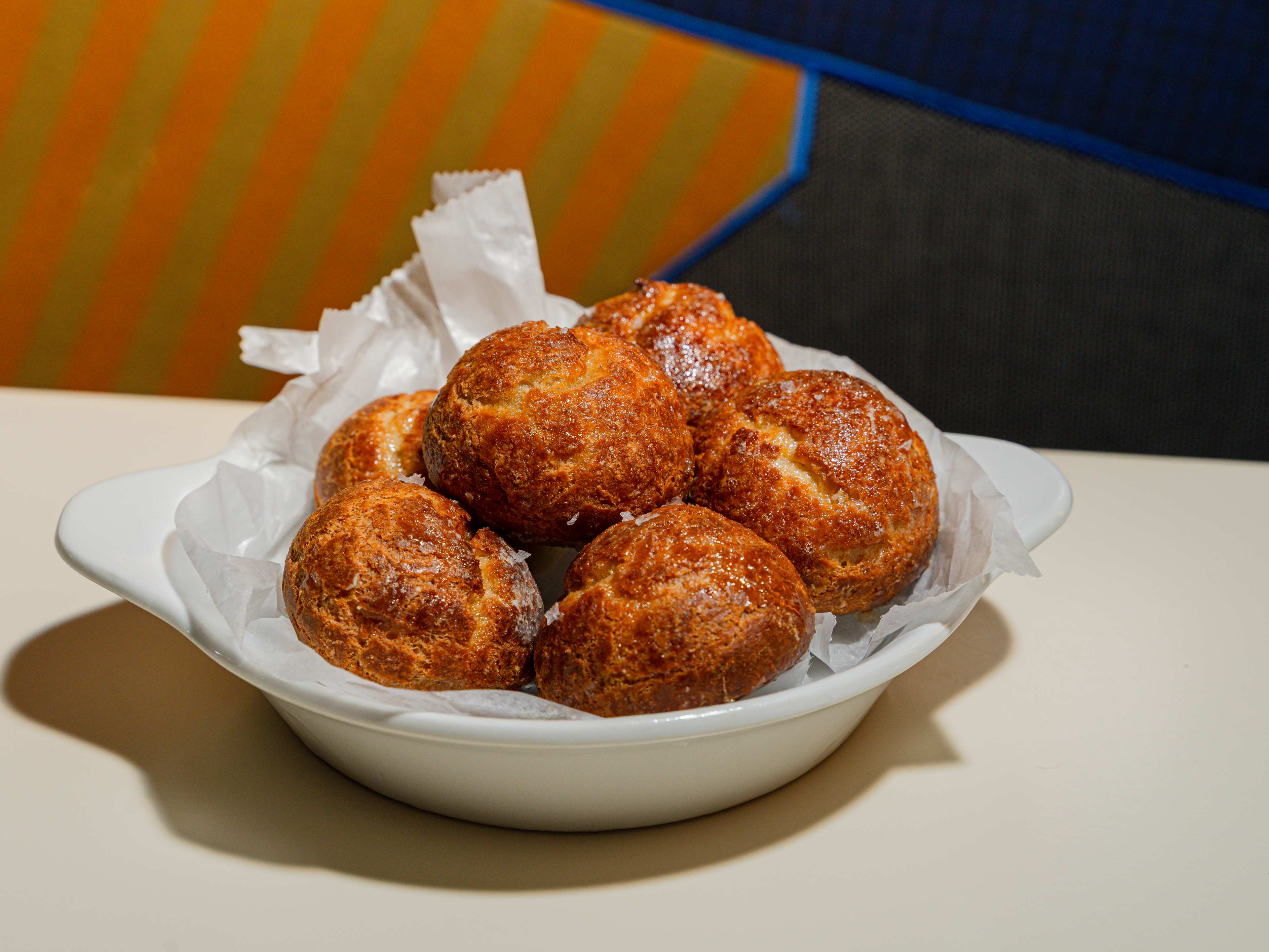 A bowl of brie gougeres.