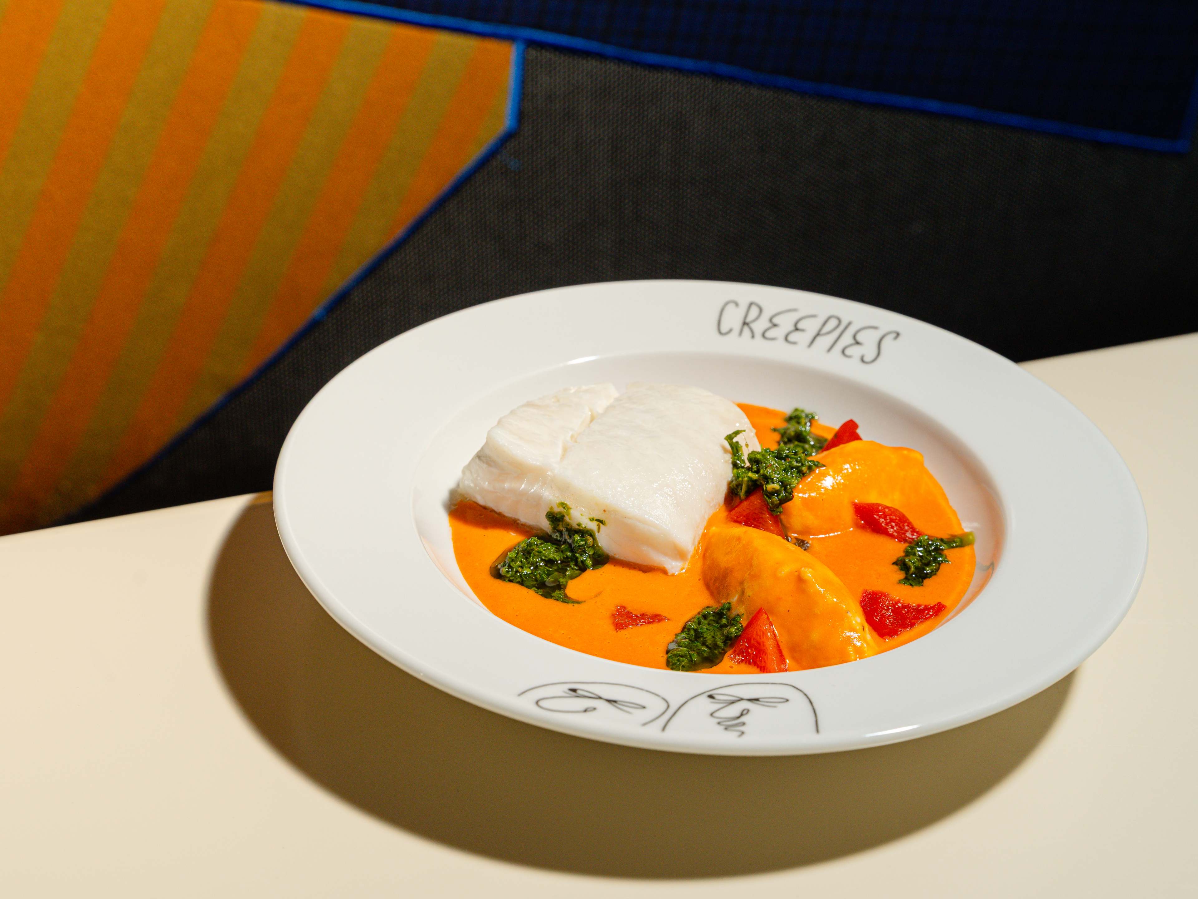 A plate of halibut with sauce homard.