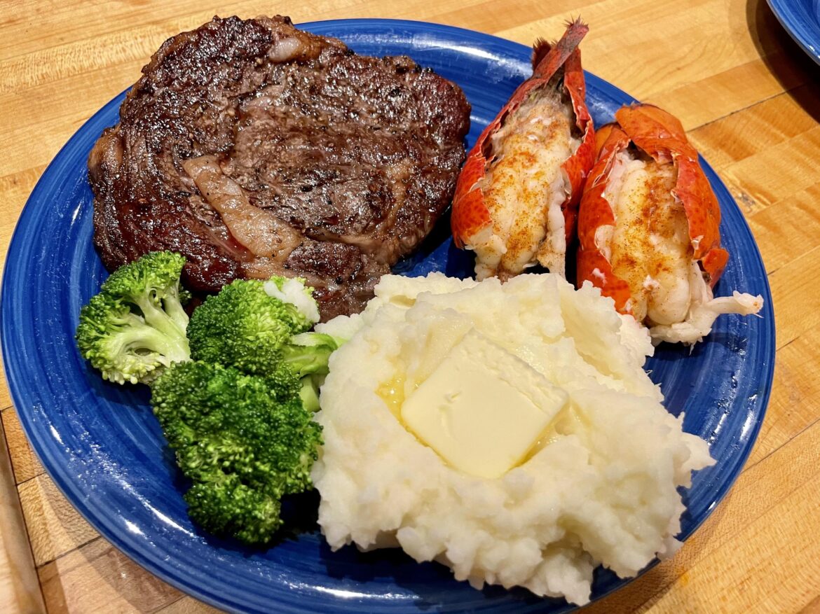 Ribeye, lobster tail, buttery mashed potatoes and steamed broccoli.