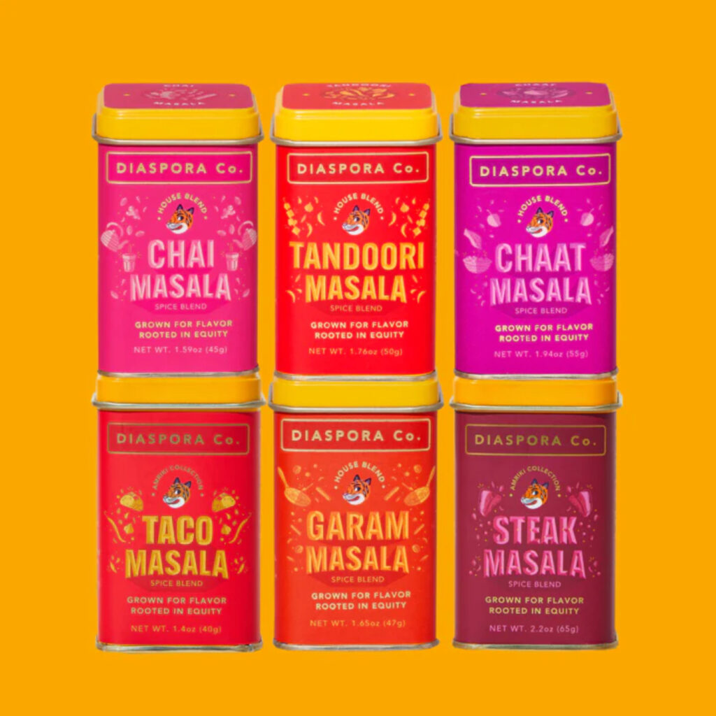 Six colorful tins of spices from Diaspora Co.: Chai Masala, Tandoor Masala, Chaat Masala, Taco Masala, Garam Masala, Steak Masala