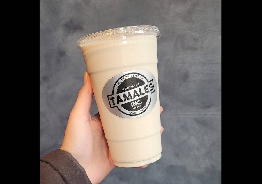 Hand holding a cup of frozen horchata