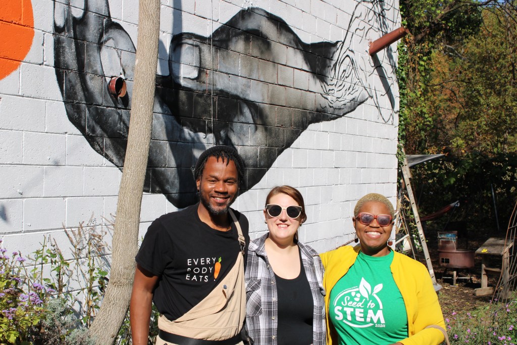 Everybody Eats founder Shawn DeAngelo Walton (from left) stands with neighborhood volunteer Angela Freeman and Black in the Garden podcast host Colah B Tawkin. 