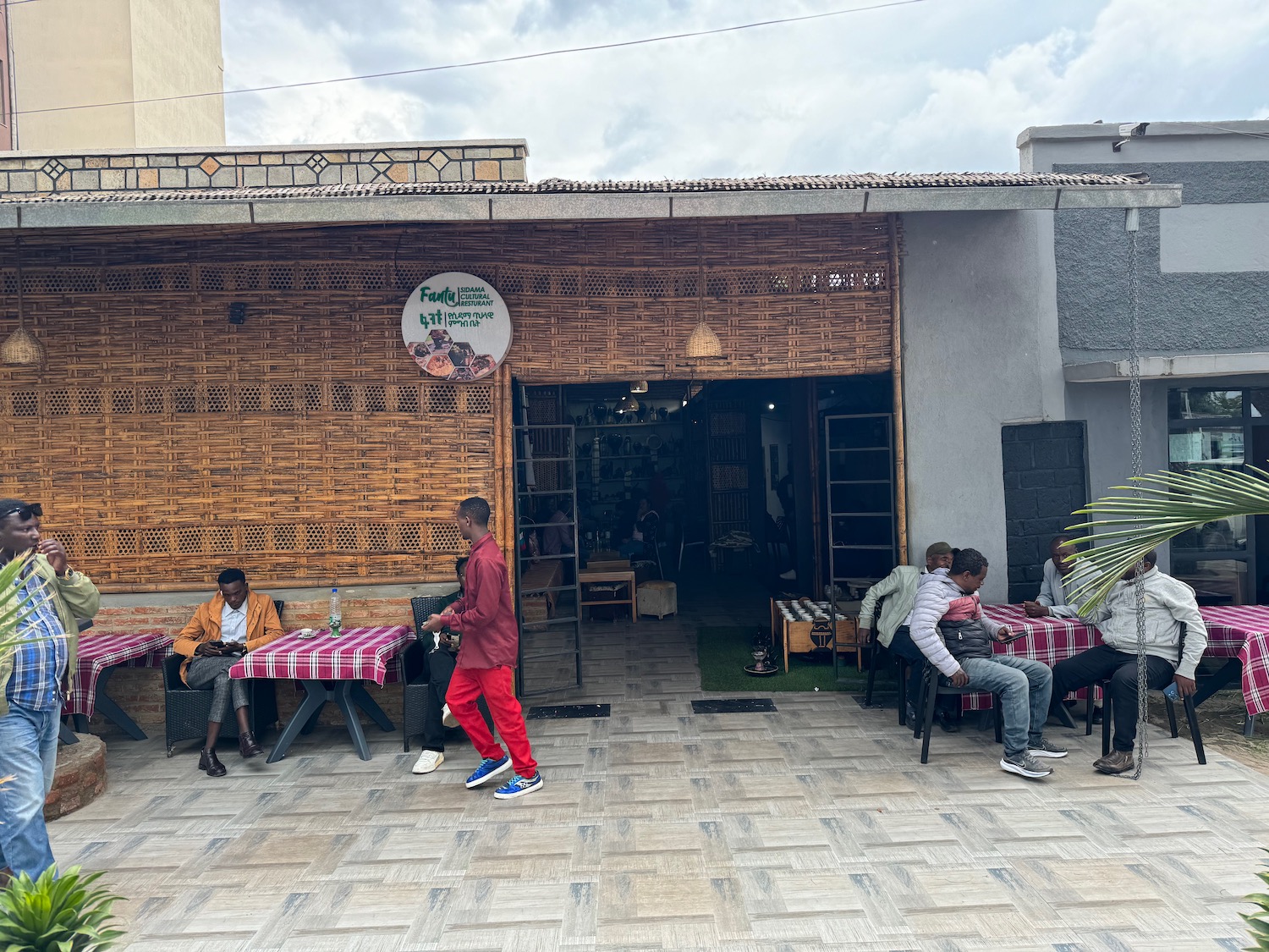 a group of people sitting outside a restaurant