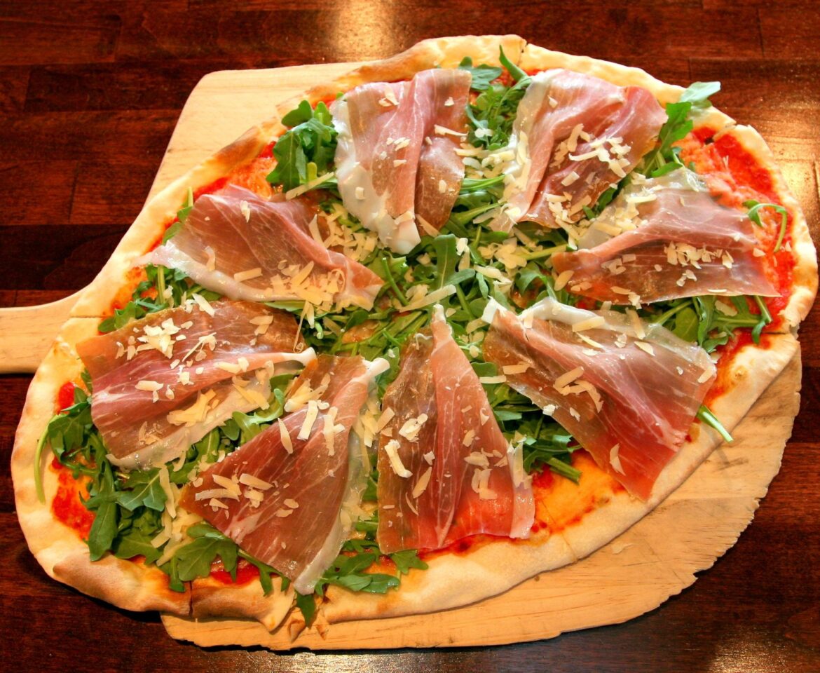 La Gitana's pizza with meat, greens and cheese