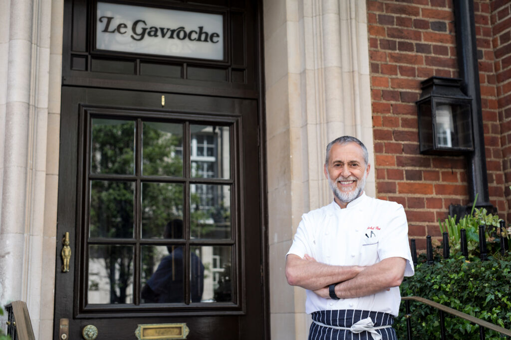 Michel standing outside Le Gavroche