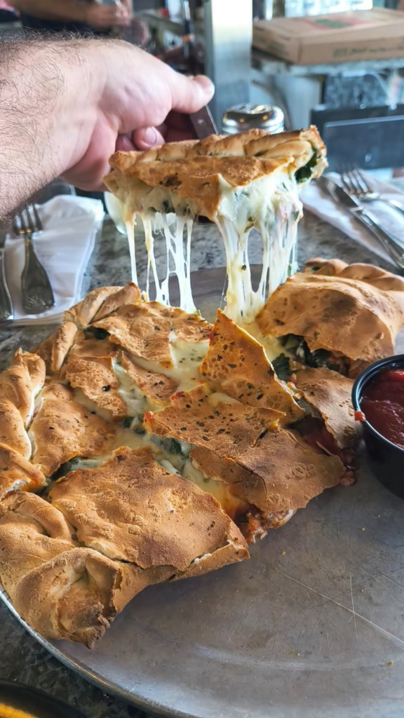Who loves a good cheese pull? This goat cheese and spinach calzone was delicious!